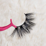 LD (5D-08) Mink Eyelashes held by pink applicator on soft background.