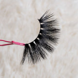 5D-10 Mink Eyelashes held by pink tweezers on a light background.