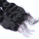 Natural curly 4x4 virgin human hair black transparent closure on white background.