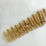 Deep wave #613 blonde human hair bundle on white background.